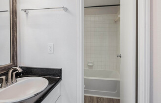a shower that has a sink and a mirror