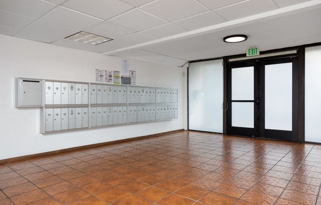 a large room with lockers on the wall and a door