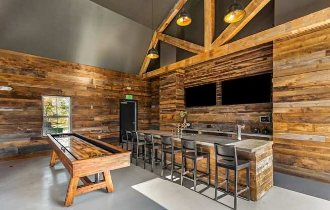 A room with wooden walls and a pool table.