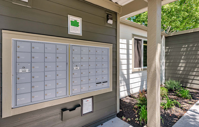A mailbox with the number 101 on it is on the side of a building.
