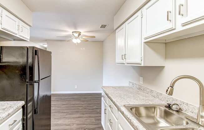 a kitchen with stainless steel appliances and white cabinets