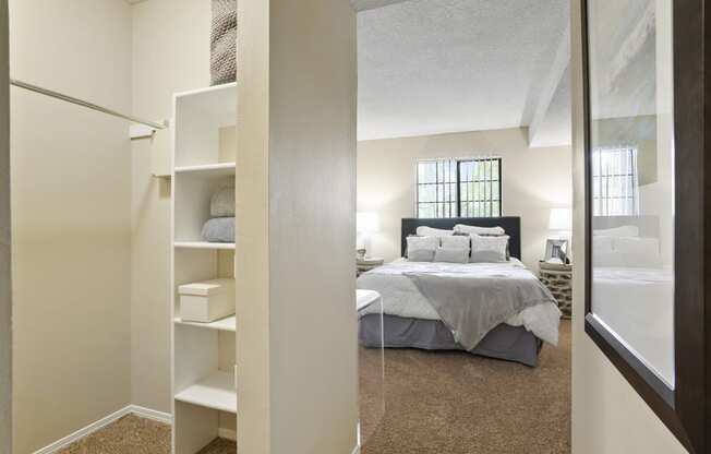 a bedroom with a large bed and a closet