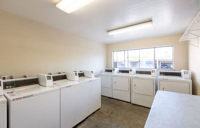 a washer and dryer room with washes and washing machines