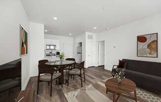 a living room and dining room with a table and chairs