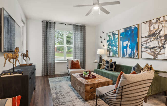 A living room with a green couch and a wooden floor.