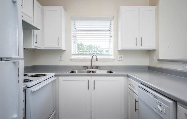 Village at Main Street | 2x2 Kitchen with White Cabinetry and Appliances and Ample Counter Space