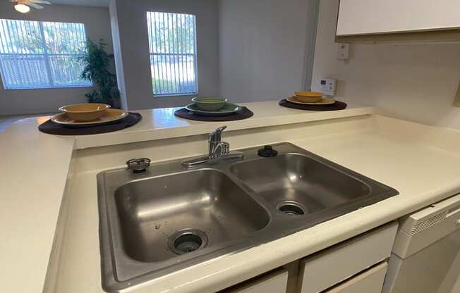 Kitchen double sink with breakfast bar overlooking living room