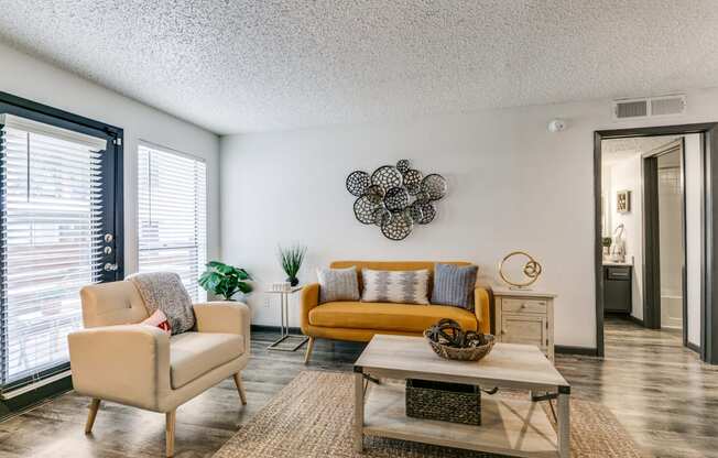 a living room with a couch and chairs and a coffee table