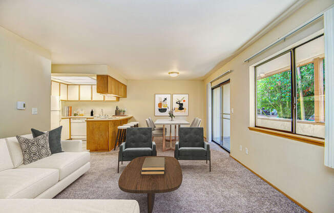 a living room with a couch and chairs and a table