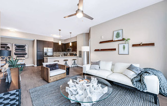 Open concept living room with ceiling fan