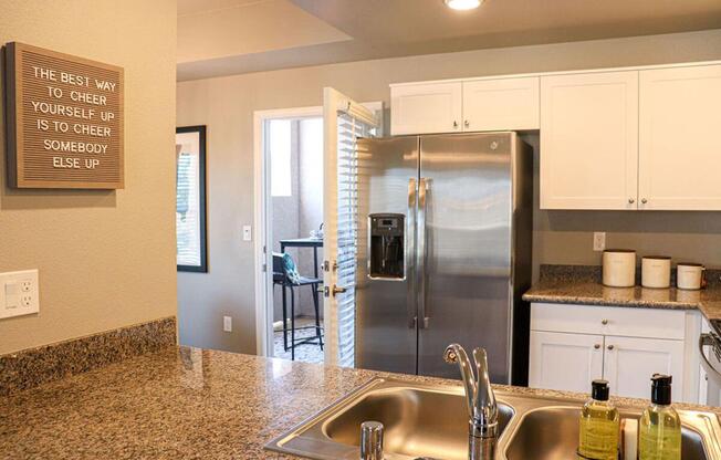 a kitchen with a sink and a mirror
