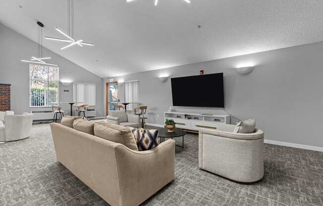 A living room with a large couch and a television.