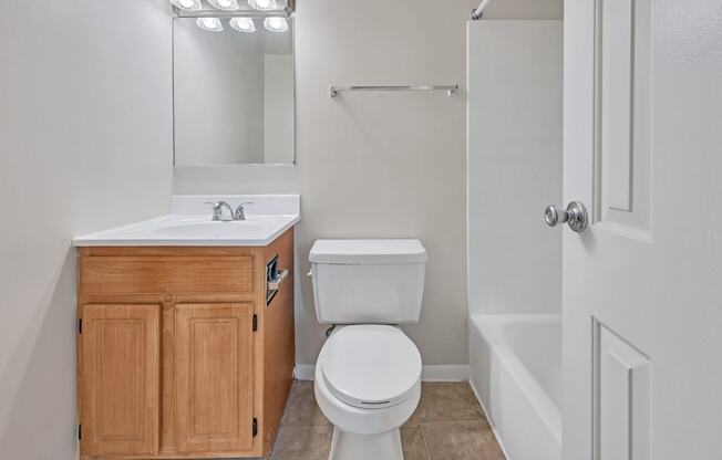 an empty bathroom with a toilet and a sink