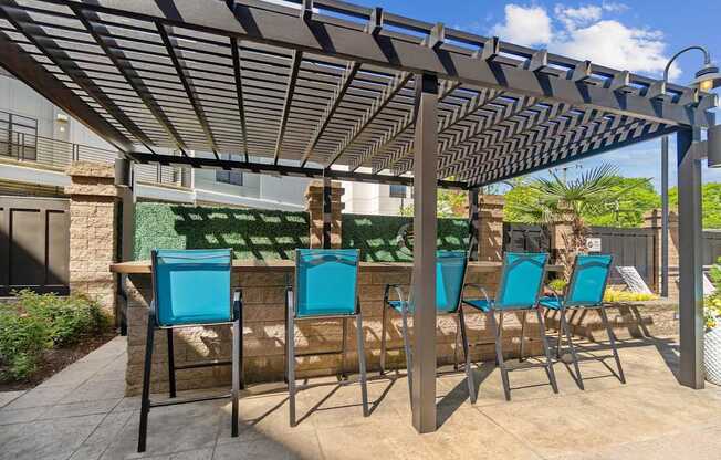 A patio with a table and chairs under a pergola.
