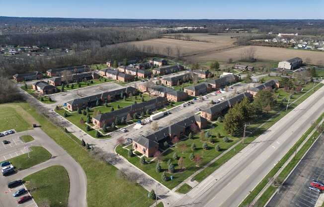 an aerial view of a neighborhood with houses and a highway