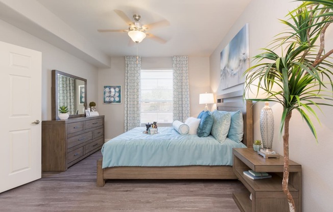 a bedroom with a large bed and a ceiling fan