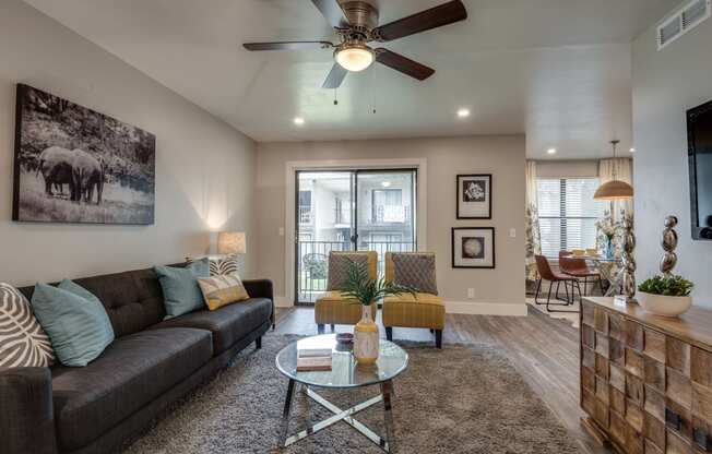 a living room with a couch and a ceiling fan