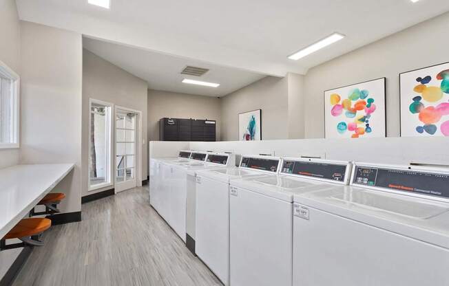 A laundromat with rows of washers and dryers.
