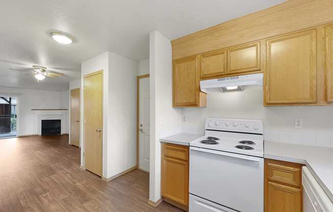 a kitchen with white appliances and wooden cabinets