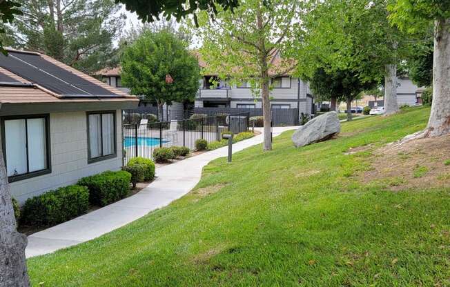 Grassy walkway around office and pool area at Dove Ridge Apartments.