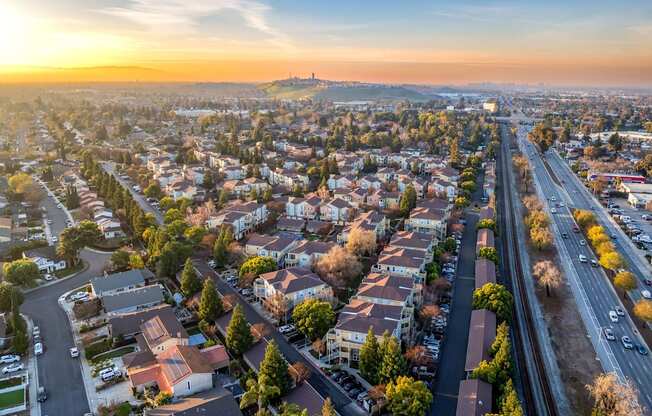 A sunset view of a city with a highway running through it.