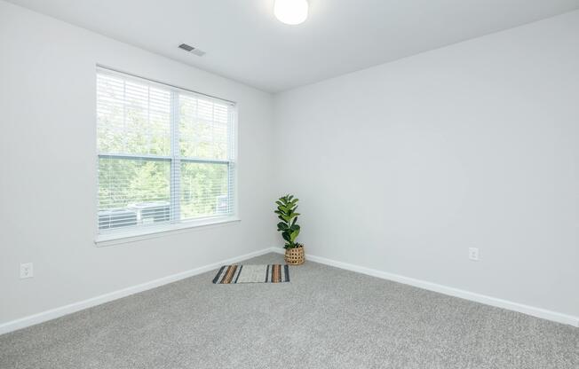 a bedroom with a large window