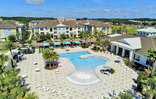Beach-entry saltwater pool with splash pad, volleyball net, swim lane and cabanas