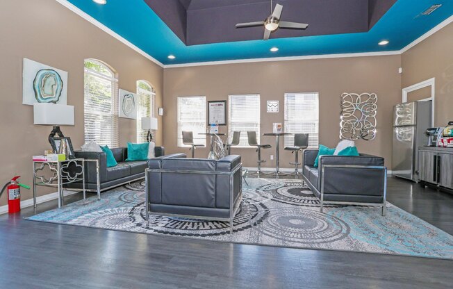 A clubhouse with a grey sofa set and a rug at The Drake in Bossier City, LA