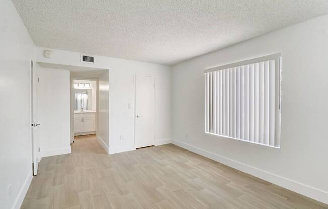 A room with a wooden floor and white walls.