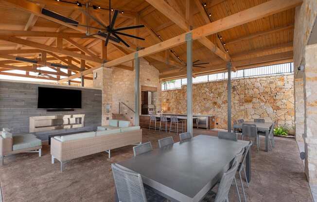 A large room with a stone wall and a wooden ceiling.