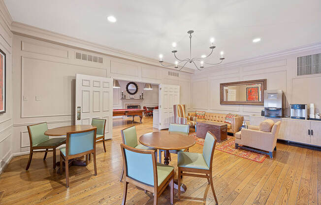 a living room with a table and chairs and a kitchen