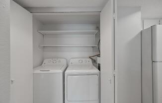 A small laundry room with a washer and dryer.