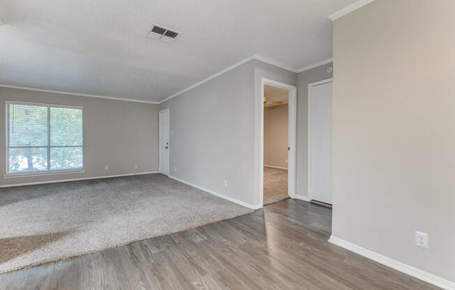 a bedroom with hardwood floors and grey walls