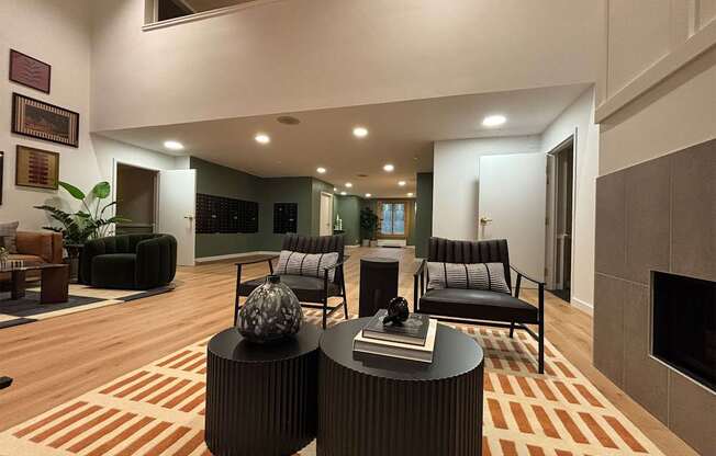 A living room with a fireplace and a striped rug.