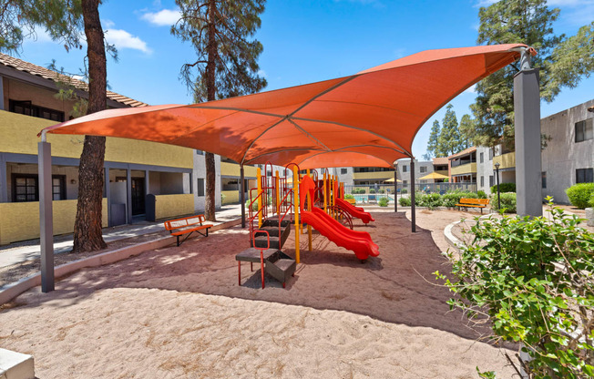 a playground with a swing set and slides
