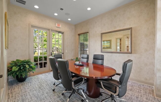 A conference room with a large table and chairs.