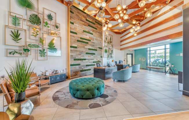 the lobby of a hotel with a reception area and plants on the wall at Metro Gateway, Riverside, CA