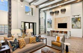 A living room with a couch, chairs, and a fireplace.