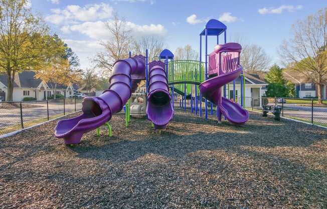 A playground with purple slides at Grand Reserve Columbus in Columbus, GA