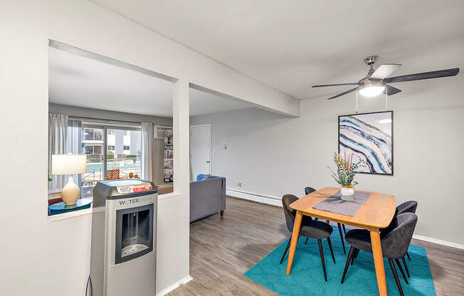 A dining room with a table and chairs.