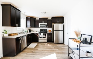 Kitchen with dark cabinets and white walls at Hudson Ridge, Red Lion, PA