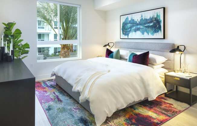 Woodland Hills, CA Pet-Friendly Apartments - The Q Variel - Bedroom with Luxury Wood Plank Style Flooring and an Oversized Window