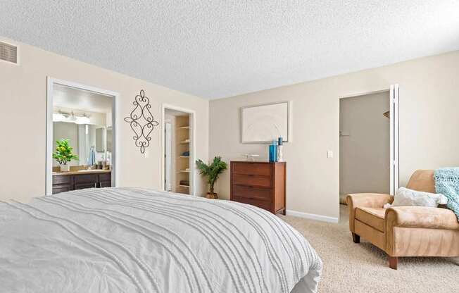 A bedroom with a large bed and a couch.