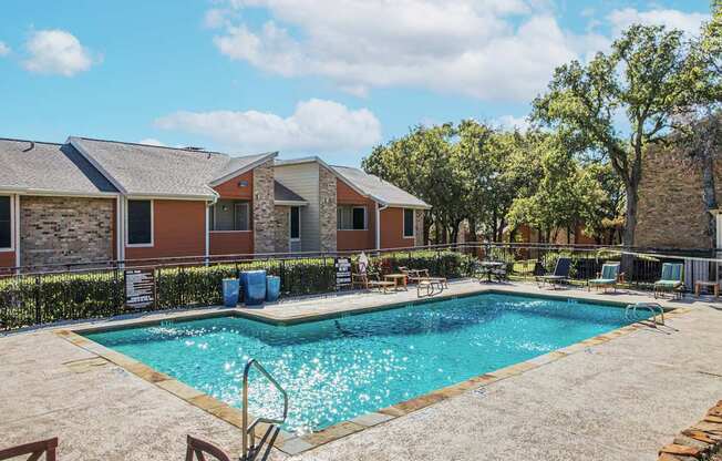 our apartments have a swimming pool and a patio with chairs