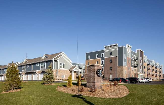 A sign with the letter E on it is in front of a building.