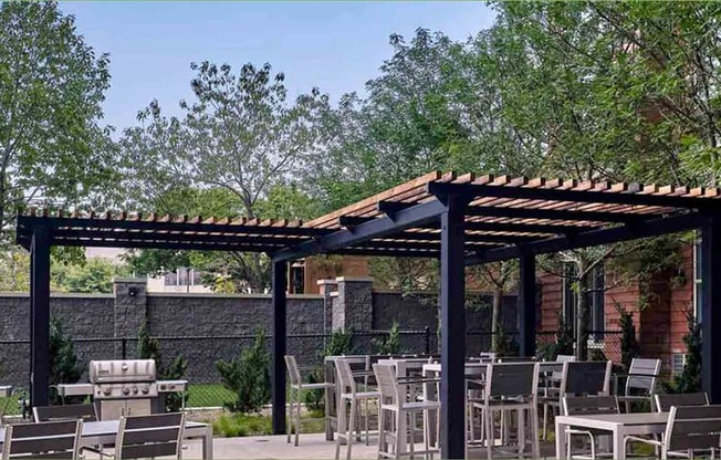 a patio with tables and chairs and a pergola at Shearwood Station, New York