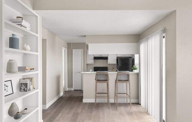 A kitchen with a bar stool in front of it.