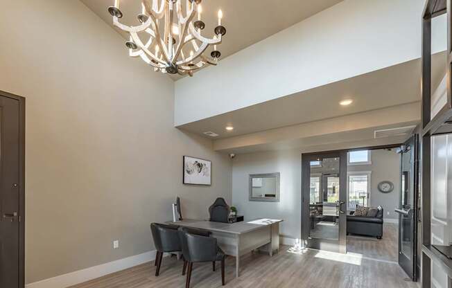 A modern dining room with a large table and chairs.