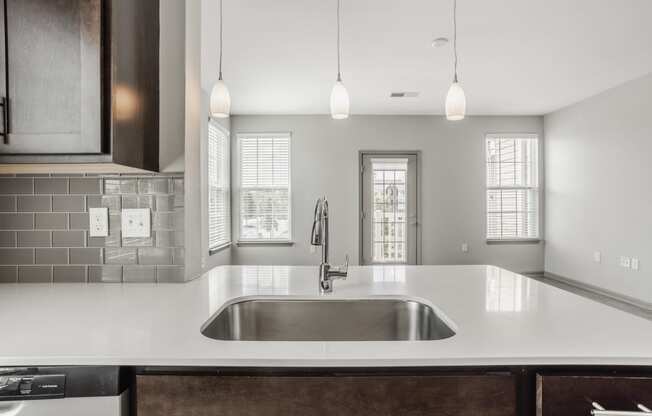 a kitchen with white counter tops and a sink