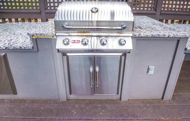 a stainless steel barbecue with granite countertops